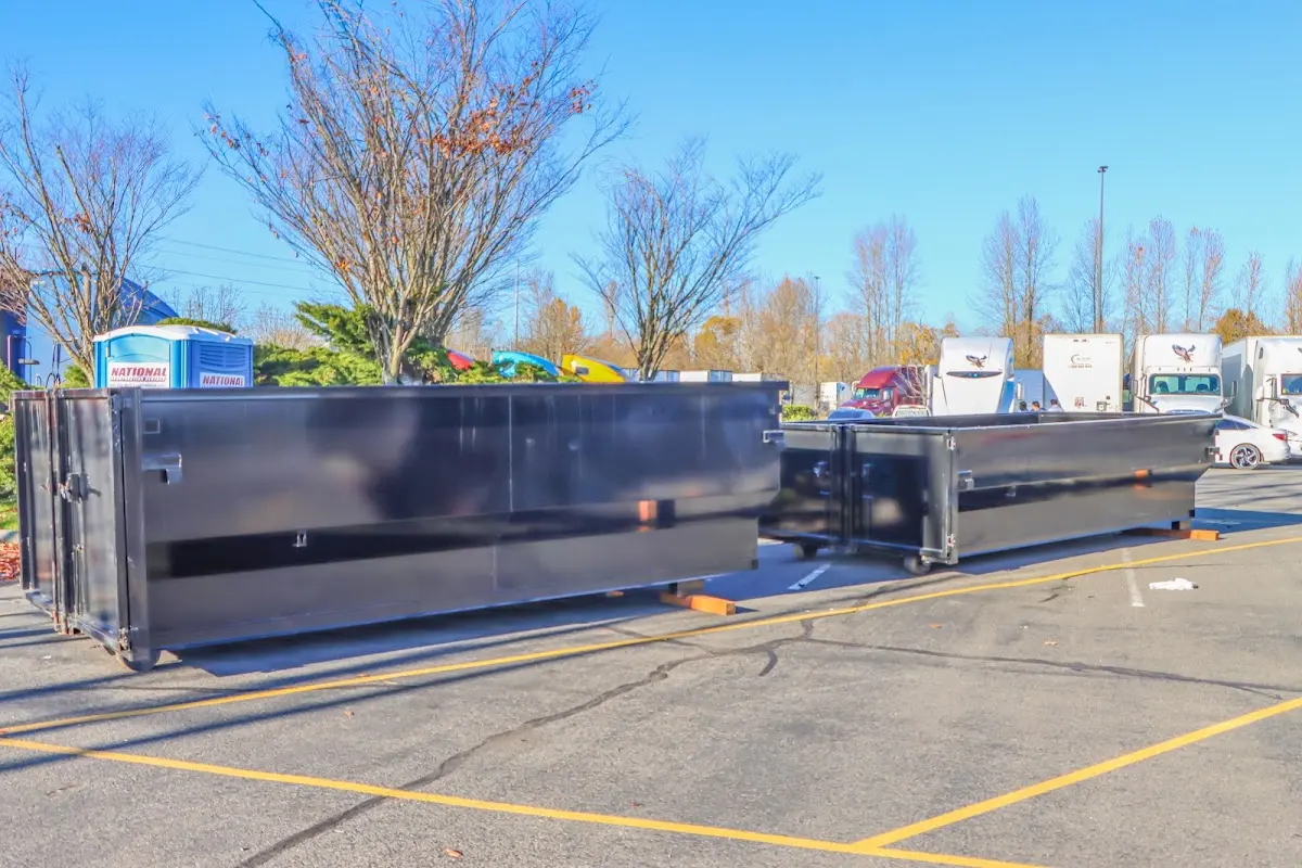 Professional dumpster rental service with roll-off container on residential driveway in Eloy